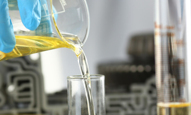 A beaker pouring chemicals.